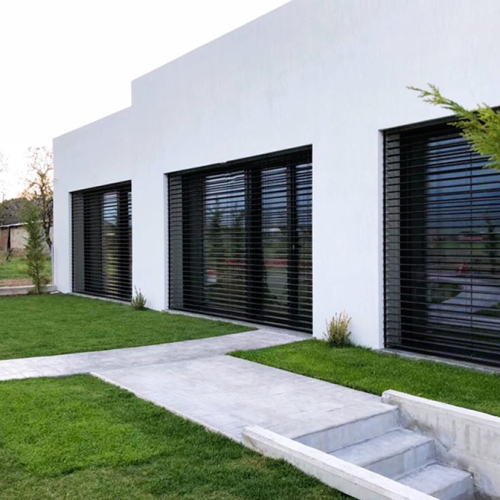 Exterior view of a building by XG Group of Engineers in Almyros, featuring the garden and façade